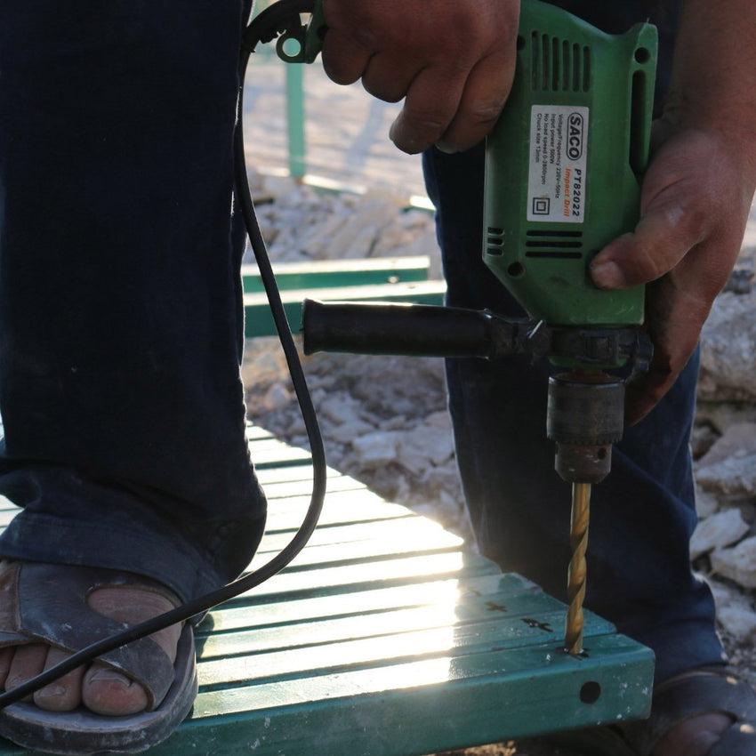 Man working with a drill in Iraq