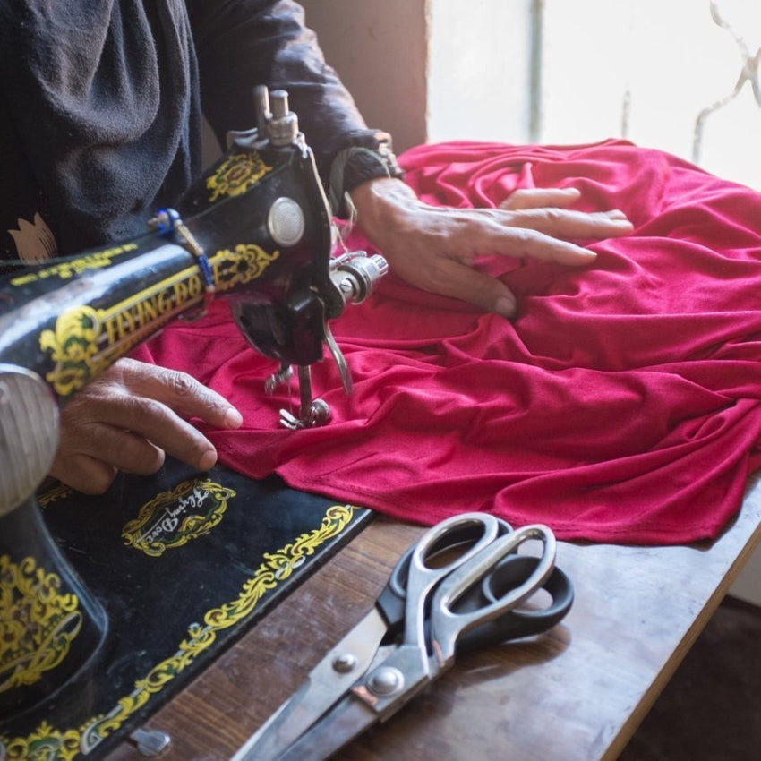 Woman and sewing machine making clothes