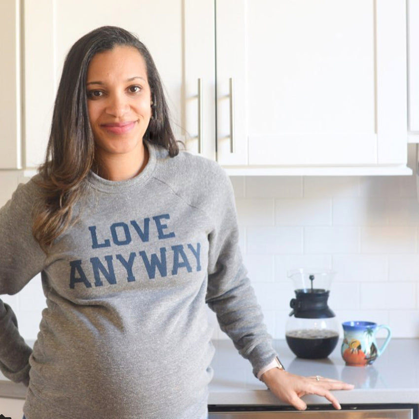 Woman wearing Love Anyway Sweatshirt, comfy sweater! 